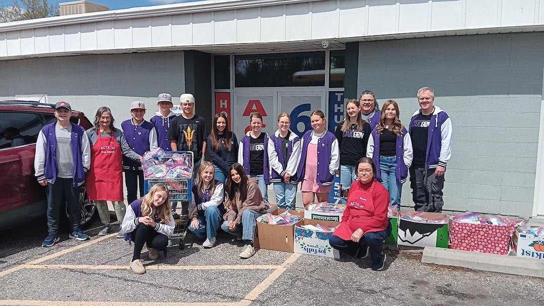 soup kitchen board members with Box Elder High School check