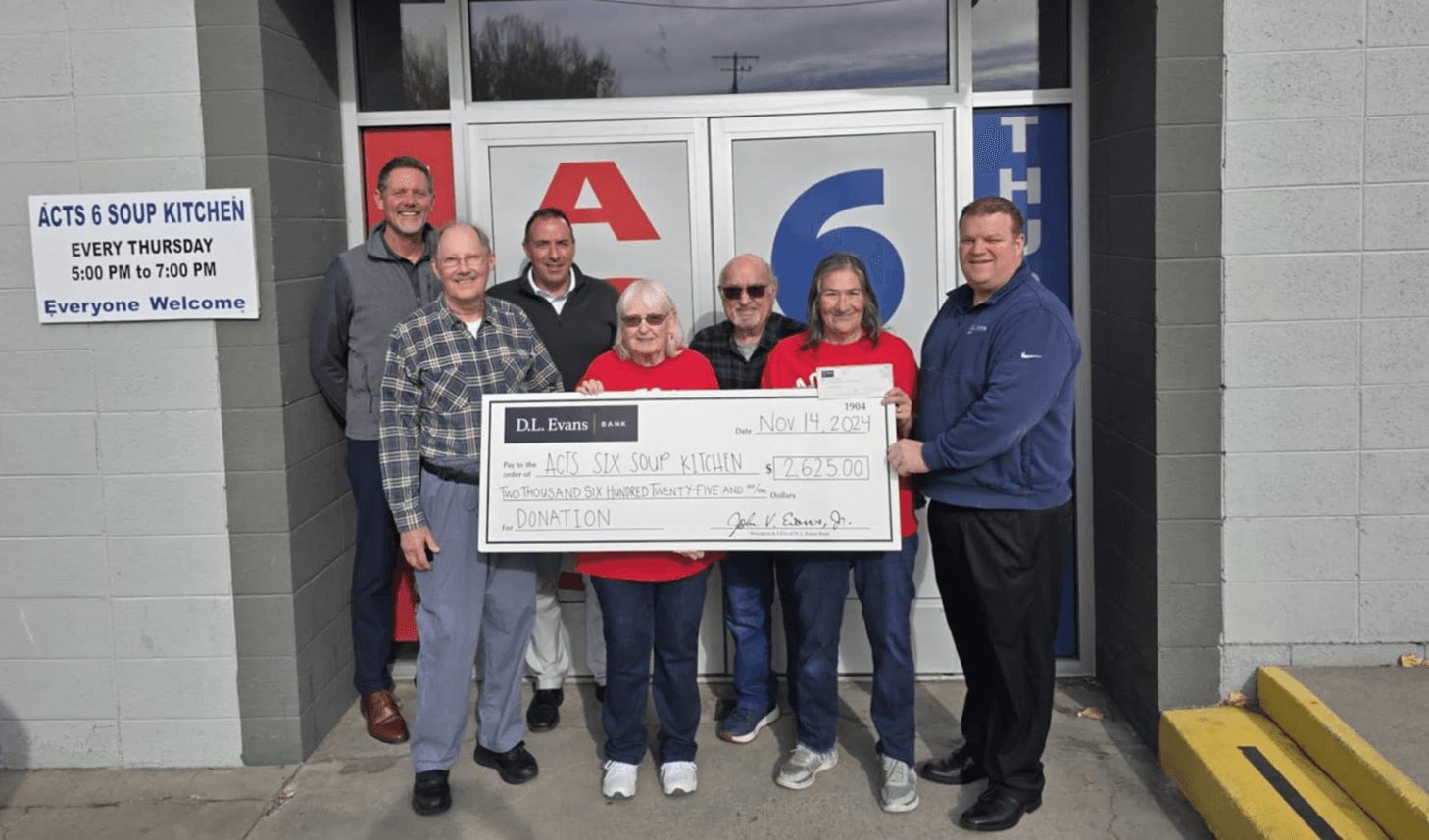 soup kitchen board members with DL Evans Bank check